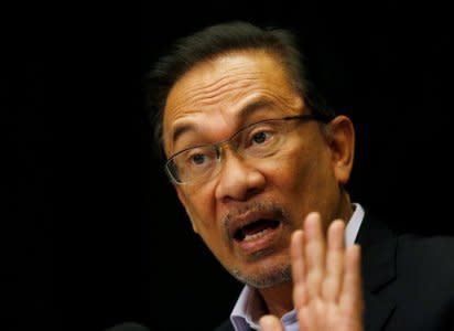 FILE PHOTO: Malaysia's opposition leader Anwar Ibrahim speaks to the media in Kuala Lumpur February 4, 2015. REUTERS/Olivia Harris/File Photo