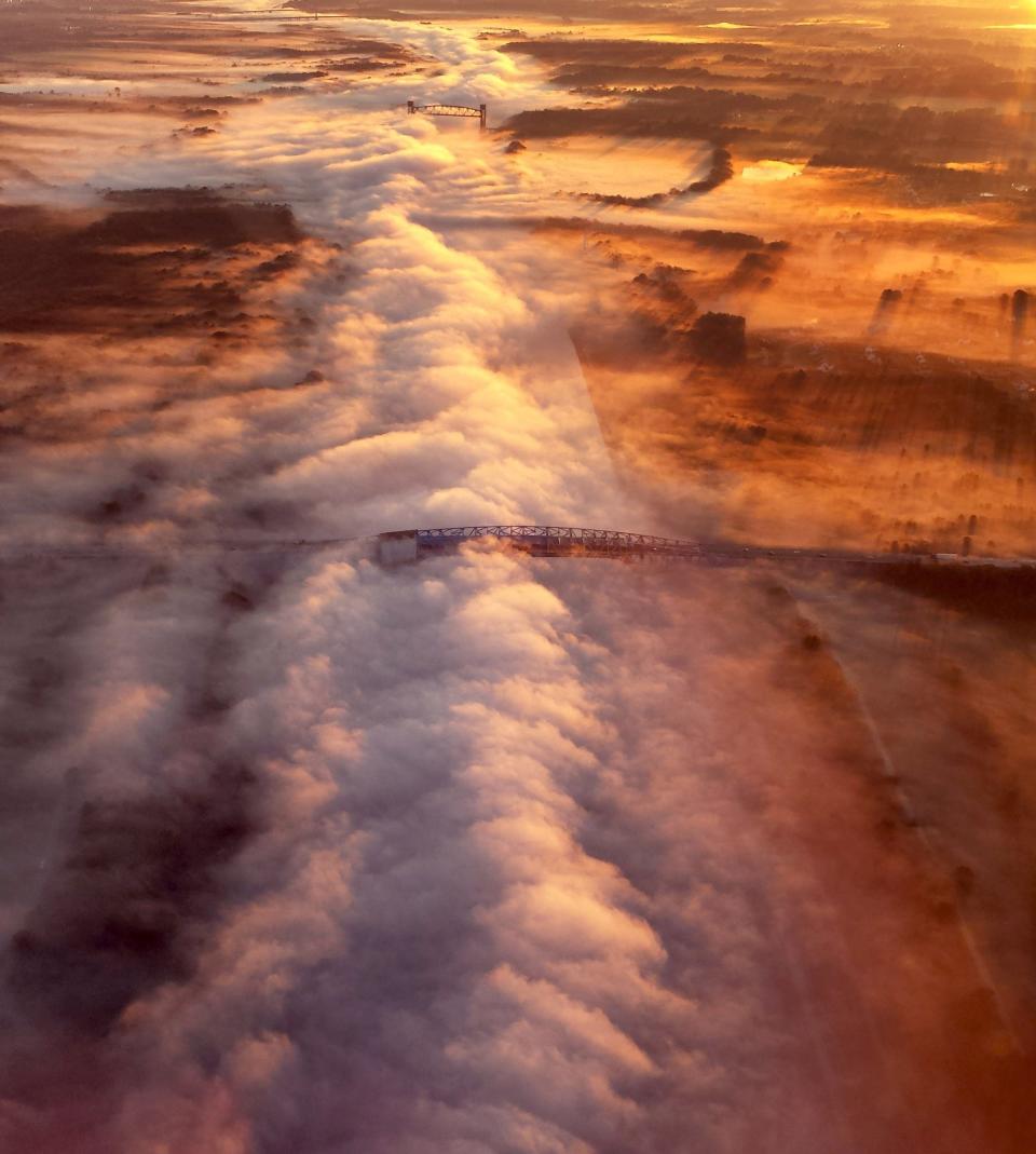 Ron Yoscak of Wilmington snapped this picture in 2013 while flying past Summit Bridge, capturing the C&D canal filled with thick fog shortly after sunrise. Summit Bridge is in the foreground.  Yoscak flew as a search and rescue air crewman with the U.S. Air Force Auxiliary Civil Air Patrol.