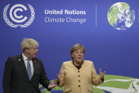 FILE - British Prime Minister Boris Johnson, left, greets German Chancellor Angela Merkel as she arrives at the COP26 U.N. Climate Summit in Glasgow, Scotland, on Nov. 1, 2021. Merkel has been credited with raising Germany’s profile and influence, helping hold a fractious European Union together, managing a string of crises and being a role model for women in a near-record tenure. Her designated successor, Olaf Scholz, is expected to take office Wednesday, Dec. 8, 2021. (AP Photo/Alastair Grant, Pool, File)