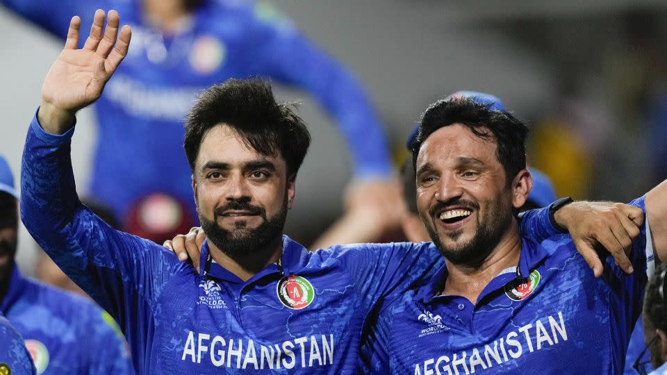 Khan (left) and Naib (right) celebrate after defeating Bangladesh by eight runs. - Ricardo Mazalan/AP