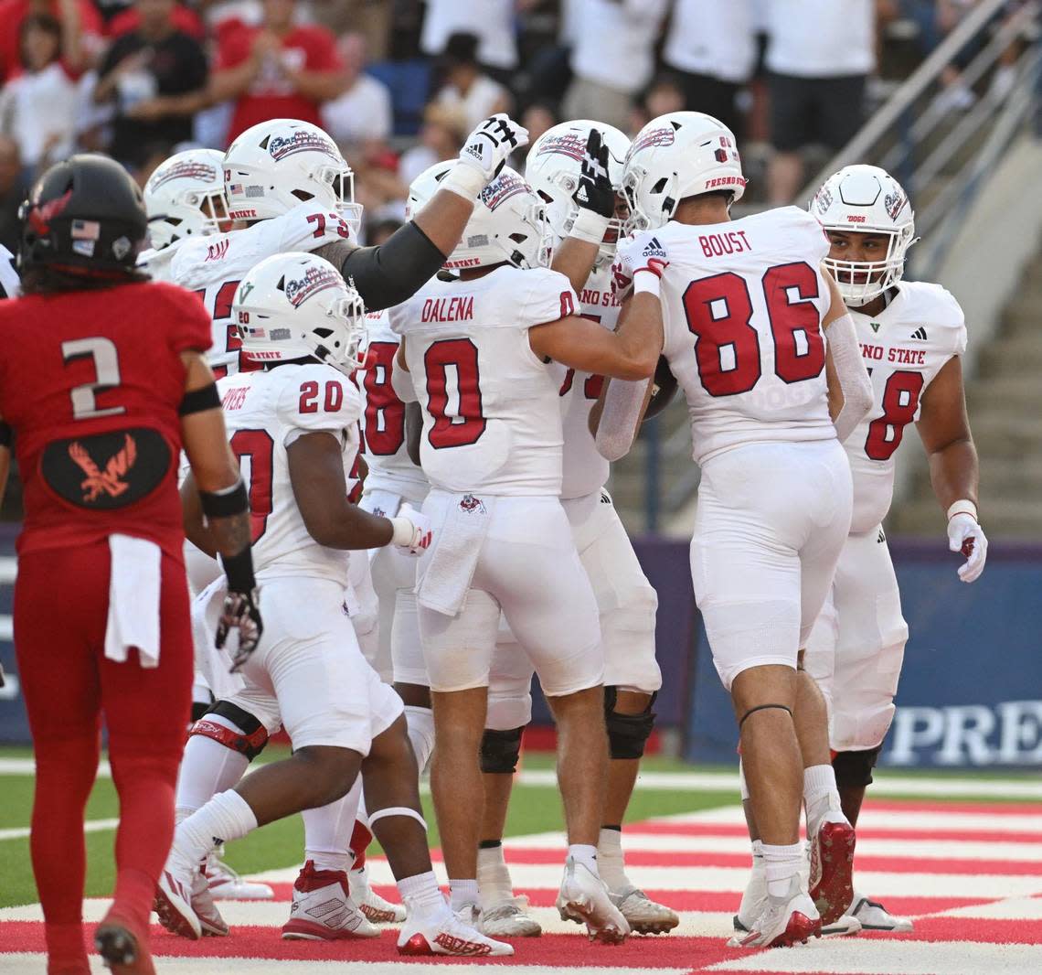 Fresno State players congratulate tight end Jake Boust, right, after catching a touchdown pass against Eastern Washington at Valley Children’s Stadium on Saturday, Sept. 9, 2023.