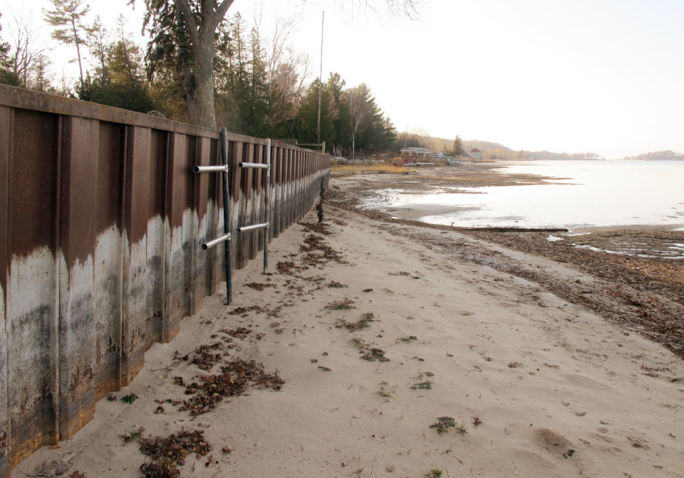 In this Nov. 16, 2012 photo, the white streaks on a steel breakwall show the normal water level on Portage Lake at Onekama, Mich., which is connected by a channel to Lake Michigan. Levels across much of the Great Lakes are abnormally low, causing problems for small harbor towns that rely on boating and water tourism. The Great Lakes, the world’s biggest freshwater system, are dropping because of drought and climbing temperatures, a trend that accelerated with this year’s almost snowless winter and scorching summer. (AP Photo/John Flesher)