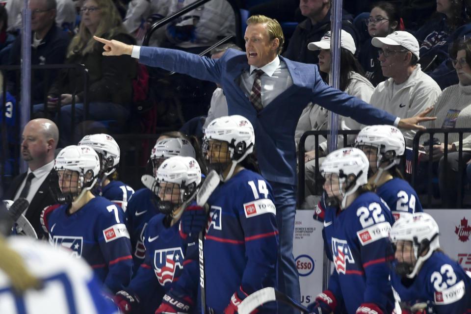United States head coach John Wroblewski, top center, yells instructions to his players during the second period against Finland in the semifinals at the IIHF women's world hockey championships in Utica, N.Y., Saturday, April 13, 2024(AP Photo/Adrian Kraus)