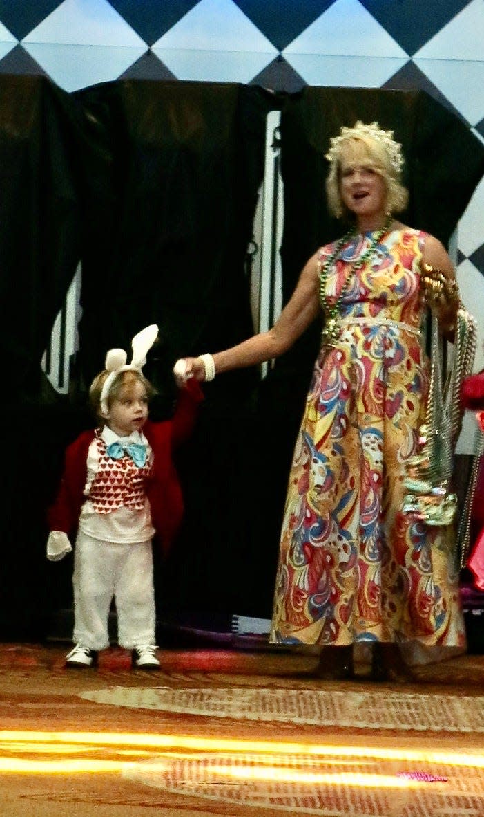 Harrison Byrd escorts his grandmother Justinian XXX Queen Alison Byrd as they come out of "The Rabbit Hole" for their presentation at the Krewe's coronation event in August 2023.