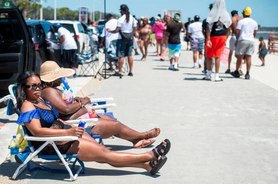 Spring breakers relax next to Biloxi Beach during Black Spring Break on Saturday, April 13, 2024.