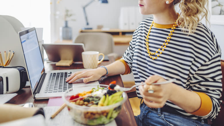 eating Buddha bowl and working