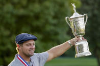 Bryson DeChambeau, of the United States, holds up the winner's trophy after winning US Open Golf Championship, Sunday, Sept. 20, 2020, in Mamaroneck, N.Y. (AP Photo/John Minchillo)