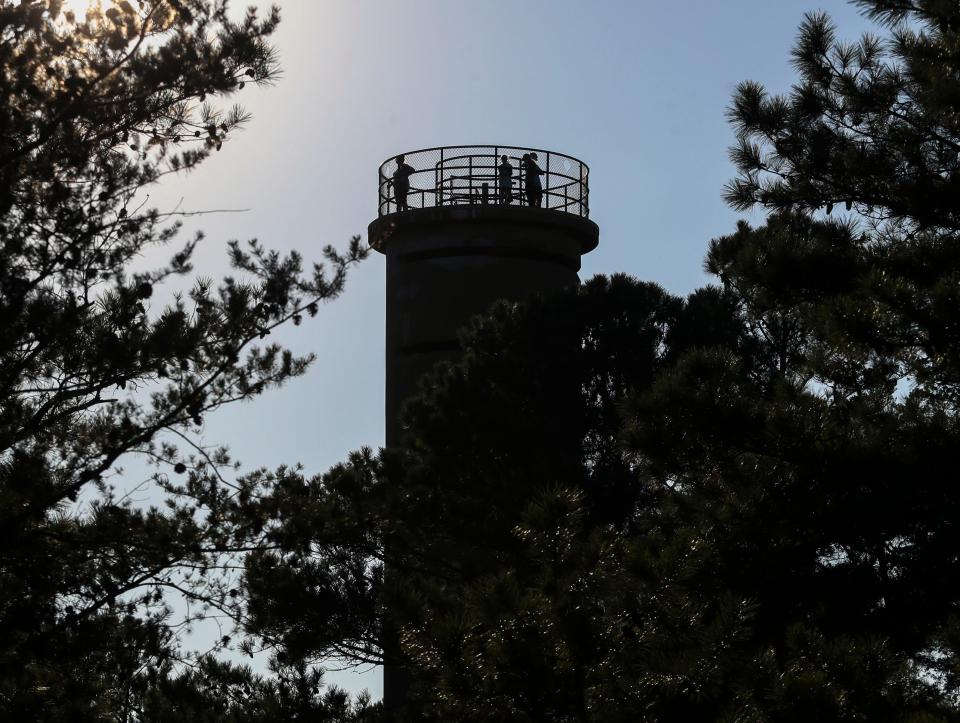 People look out from a Fire Control Tower near Fort Miles at Cape Henlopen State Park.