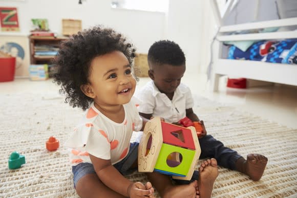 Two kids playing with toys.