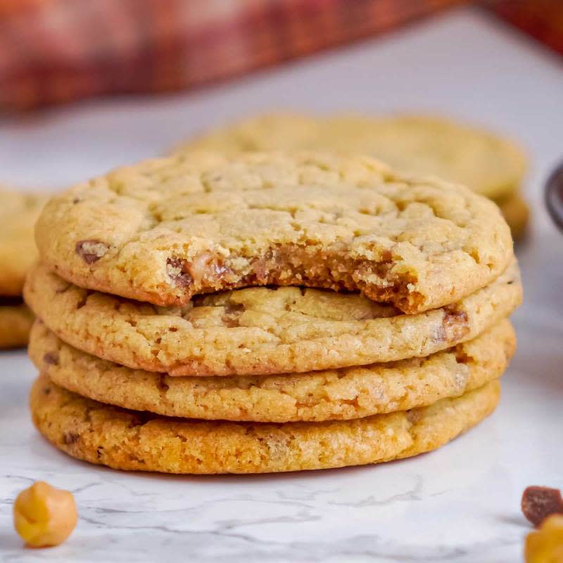 <p>The Chunky Chef</p><p>These chewy pumpkin cookies are studded with bits of toffee and caramel, and baked until soft and tender. The perfect fall dessert, these cookies go great with a cold glass of milk! </p><p><strong>Get the recipe: <em><a href="https://www.thechunkychef.com/toffee-crunch-pumpkin-cookies/" rel="nofollow noopener" target="_blank" data-ylk="slk:Toffee Crunch Pumpkin Cookies;elm:context_link;itc:0;sec:content-canvas" class="link ">Toffee Crunch Pumpkin Cookies</a></em></strong></p>