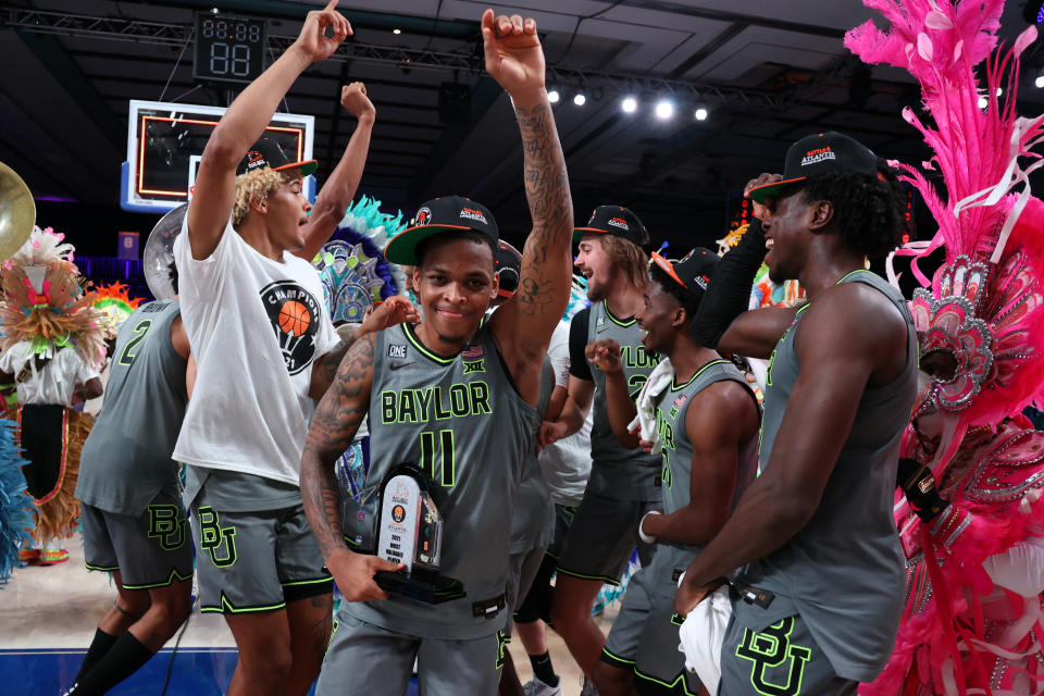 In this photo provided by Bahamas Visual Services, Baylor guard James Akinjo (11), the tournament's MVP, celebrates with teammates after defeating Michigan State in an NCAA college basketball game at Paradise Island, Bahamas, Friday, Nov. 26, 2021. (Tim Aylen/Bahamas Visual Services via AP)