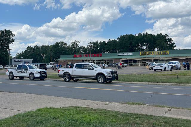 <p>Ainsley Platt/Arkansas Democrat-Gazette via AP</p> Police vehicles remain on the scene of a shooting at the Mad Butcher grocery store, Friday, June 21, 2024, Frodyce, Ark.