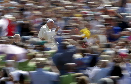 Pope Francis waves as he arrives to lead his Wednesday general audience in Saint Peter's square at the Vatican June 17, 2015. REUTERS/Max Rossi