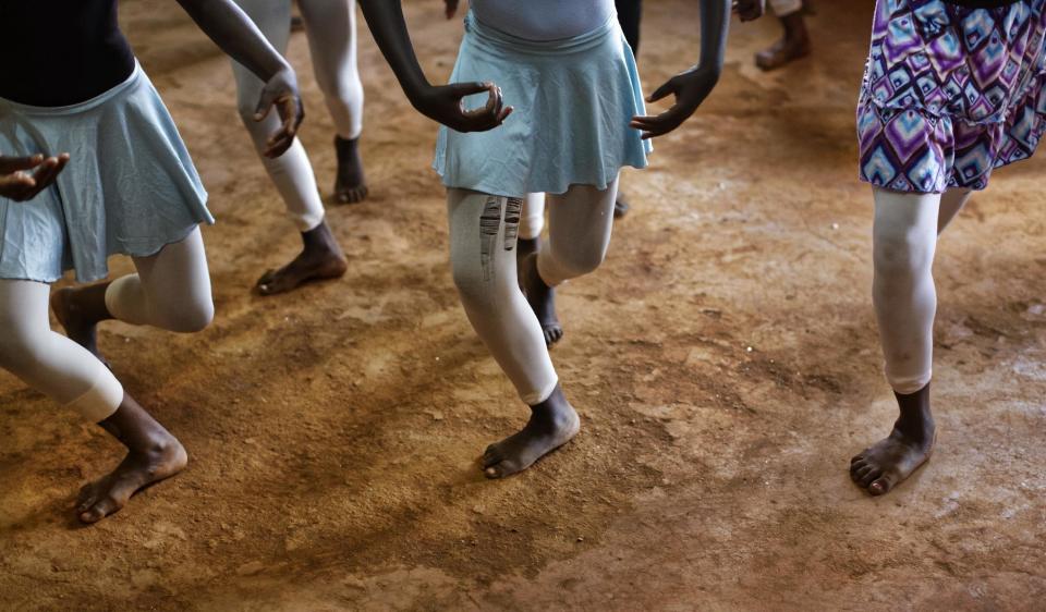 In this photo taken Friday, Dec. 9, 2016, young ballerinas practice under the instruction of Kenyan ballet dancer Joel Kioko, 16, in a room at a school in the Kibera slum of Nairobi, Kenya. In a country not usually associated with classical ballet, Kenya's most promising young ballet dancer Joel Kioko has come home for Christmas from his training in the United States, to dance a solo in The Nutcracker and teach holiday classes to aspiring dancers in Kibera, the Kenyan capital's largest slum. (AP Photo/Ben Curtis)