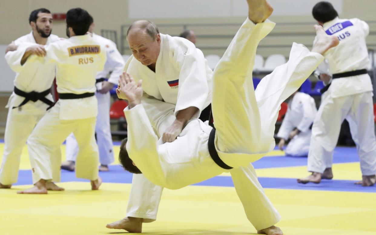 Vladimir Putin throws an Olympic gold medalist to the mat in a judo sparring session in Sochi - TASS