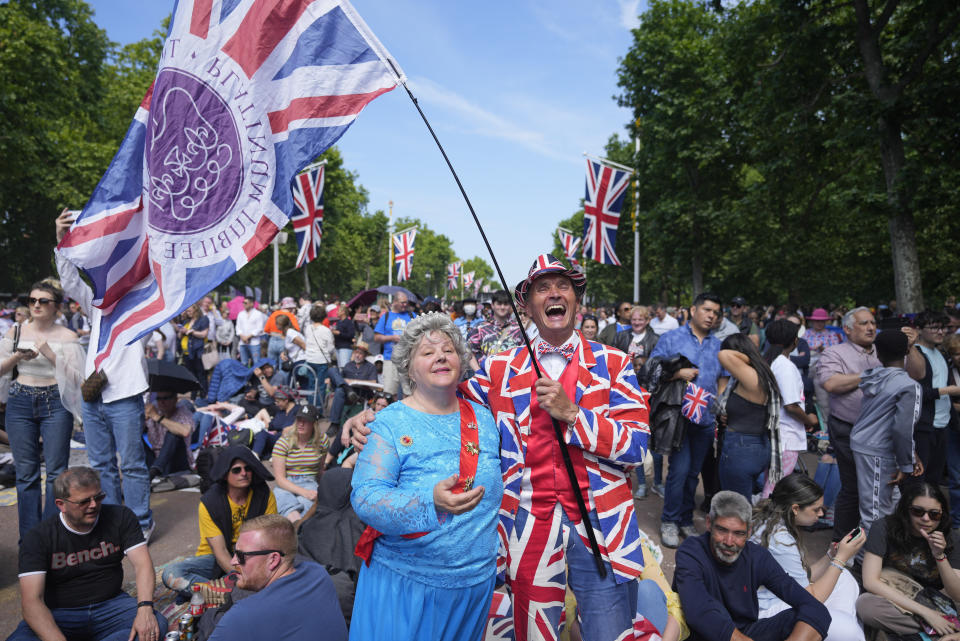 Royal fans gather on the Mall near Buckingham Palace, London, Saturday June 4, 2022 ahead of the Platinum Jubilee concert, on the third of four days of celebrations to mark the Platinum Jubilee. The events over a long holiday weekend in the U.K. are meant to celebrate Queen Elizabeth II's 70 years of service. (AP Photo/Frank Augstein)