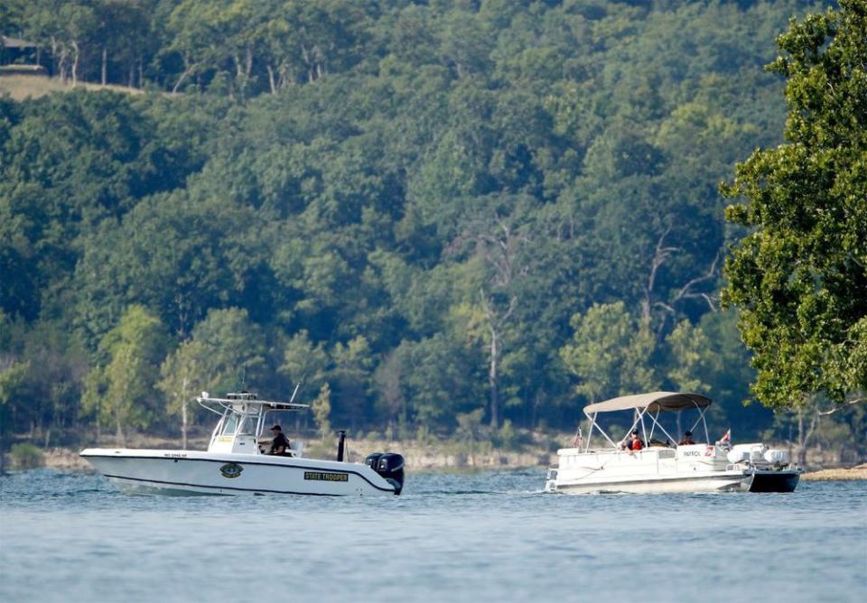 Emergency workers patrol an area, near where the duck boat capsized