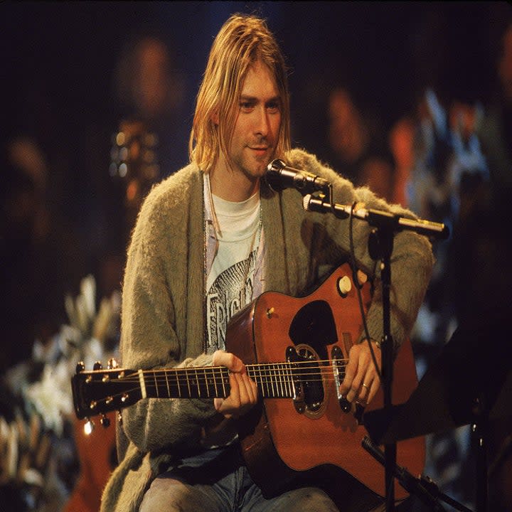Kurt sitting and playing guitar