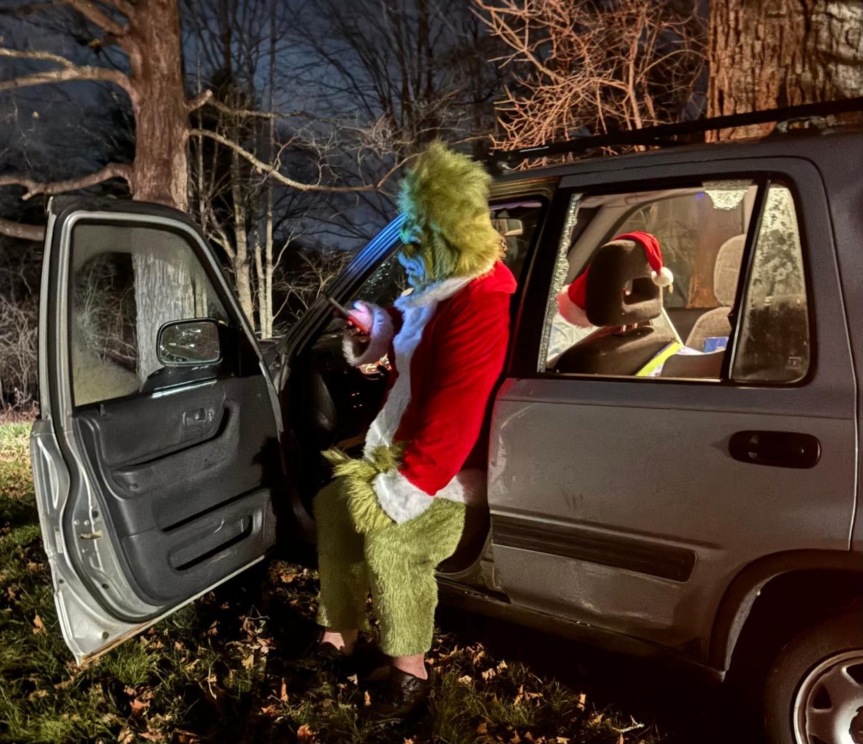 A man dressed as the Grinch was distracted and accidently drove his car through an Exeter, New Hampshire business' mailbox and road sign on Christmas night.