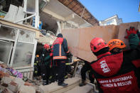 Rescuers work on searching for people buried under the rubble on a collapsed building, after an earthquake struck Elazig, eastern Turkey, Saturday, Jan. 25, 2020. Emergency workers and security forces distributed tents, beds and blankets as overnight temperatures dropped below freezing in the affected areas. Mosques, schools, sports halls and student dormitories were opened for hundreds who left their homes after the quake. (IHH/ Humanitarian Relief Foundation via AP)