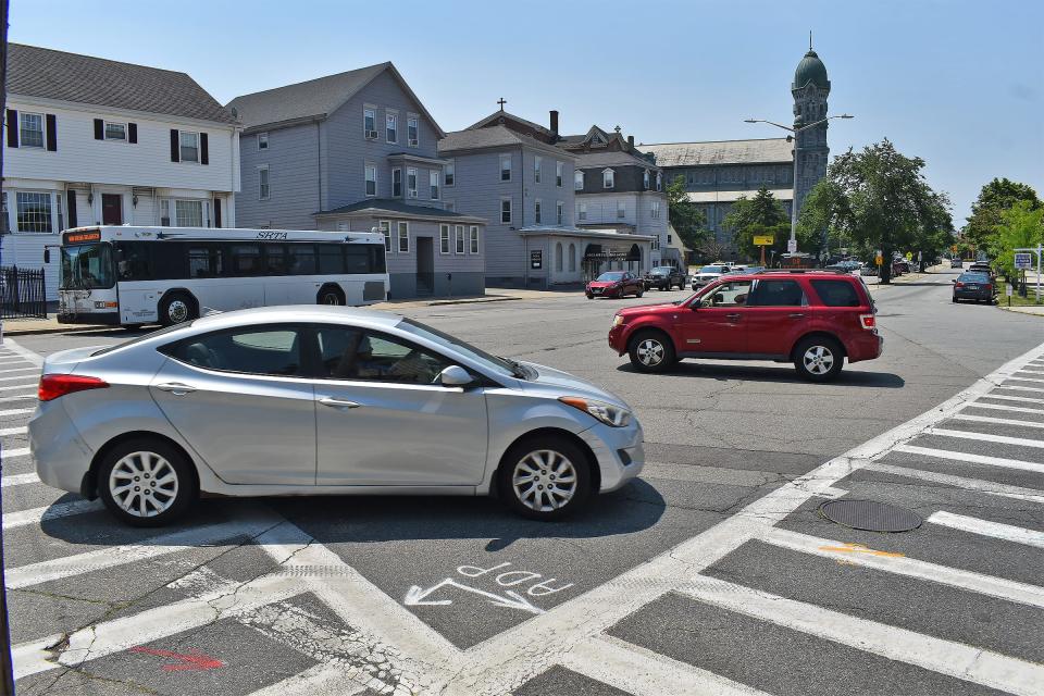 Cars and a bus zip through the corner of Bradford Avenue and South Main Street in Fall River on Tuesday, June 18, 2024. The intersection will be getting a mural painted on the asphalt thanks to a grant from the Bloomberg Philanthropies.