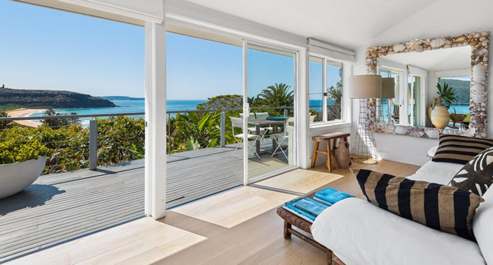 The open plan living area rolls out onto the waterfront balcony. Source: Domain