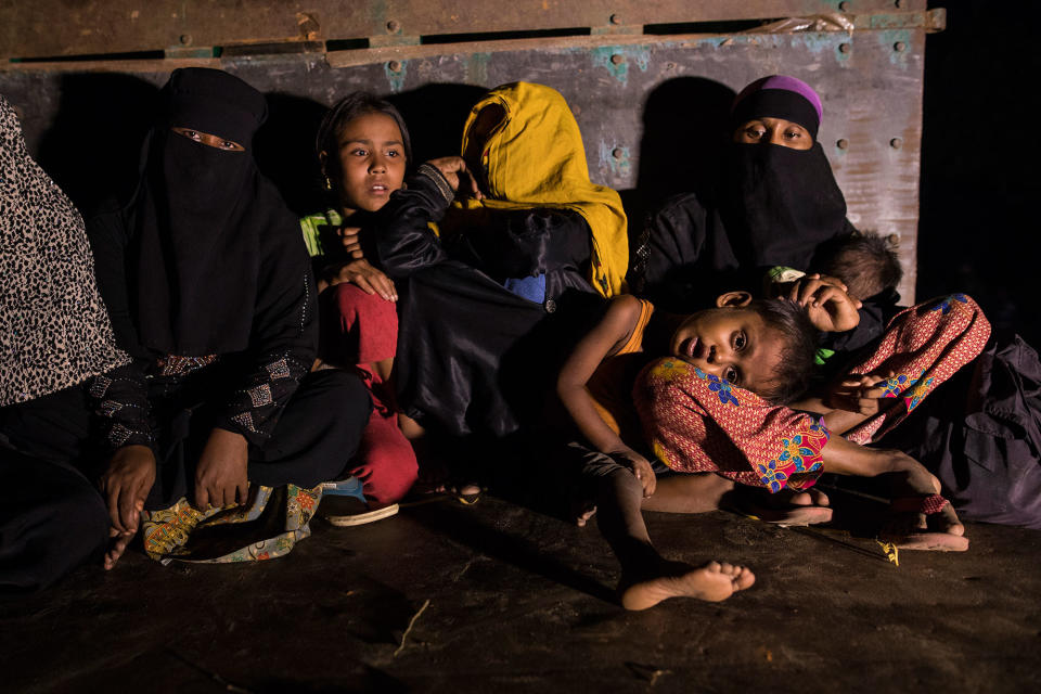 <p>Rohingya women and children sit in a truck waiting to be transported from the border area to various camps on October 13, 2017, in Teknaf, Cox’s Bazar, Bangladesh. (Photograph by Paula Bronstein/Getty Images) </p>