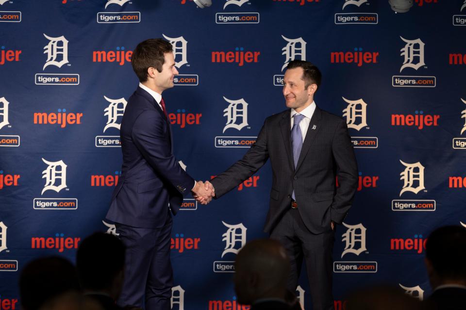 Detroit Tigers president of baseball operations Scott Harris (left) shakes hands with general manager Jeff Greenberg (right) on September 26, 2023, in the Tiger Club at Comerica Park.