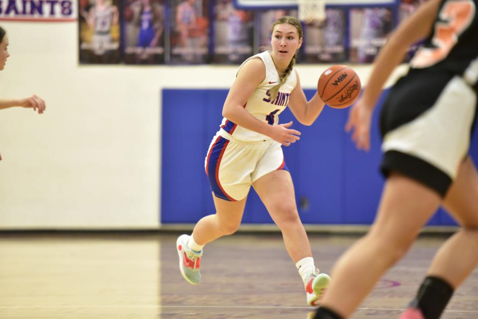 St. Clair's Erin Seros scans the floor during the Saints' 52-44 win over Marine City at St. Clair High School on Friday. She scored 11 points in the victory.