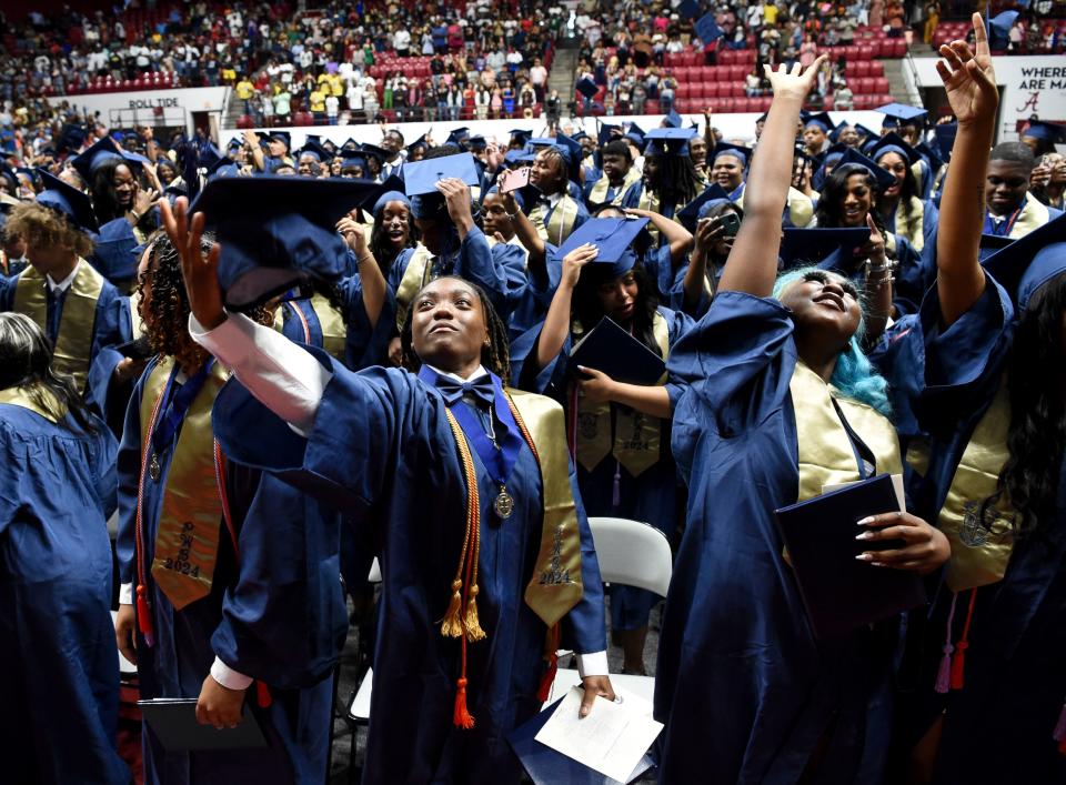 May 14 2024; Tuscaloosa, AL, USA; Paul W. Bryant High School graduates celebrate their degrees by tossing their mortar boards at Coleman Coliseum Tuesday.