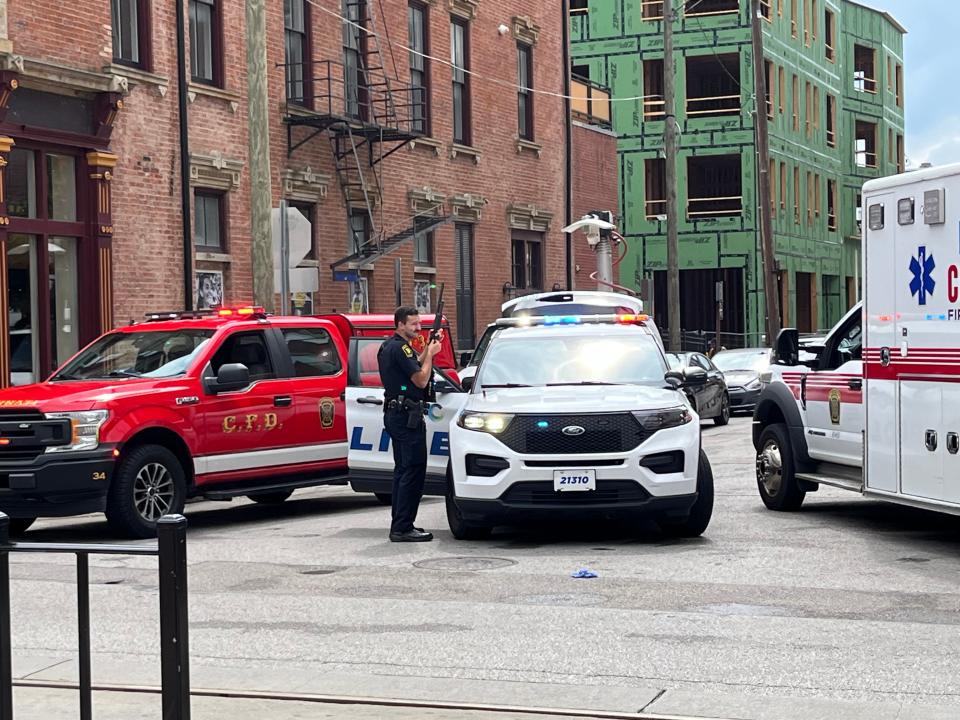 Officers were spotted with long guns after a shooting near Findlay Market on Sunday.