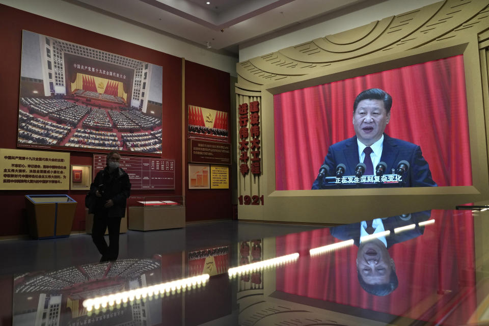 Chinese President Xi Jinping's image on a big screen is reflected on glass at the Museum of the Communist Party of China here in Beijing, China, Friday, Nov. 12, 2021. Xi emerges from a party conclave this week not only more firmly ensconced in power than ever, but also with a stronger ideological and theoretical grasp on the ruling Communist Party's past, present and future. (AP Photo/Ng Han Guan)