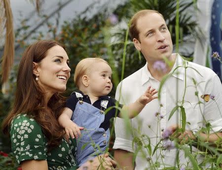 Britain's Catherine, Duchess of Cambridge, carries her son Prince George alongside her husband Prince William as they visit the Sensational Butterflies exhibition at the Natural History Museum in London, July 2, 2014. REUTERS/John Stillwell/Pool