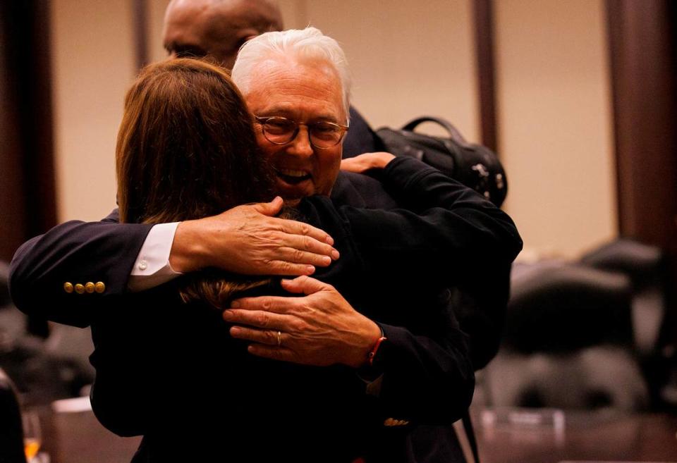 N.C. State Chancellor Randy Woodson receives a hug following a meeting of the N.C. State Board of Trustees on Thursday, July 18, 2024, in Raleigh, N.C. after announcing that he will retire next summer after a 15-year tenure leading the Wolfpack.