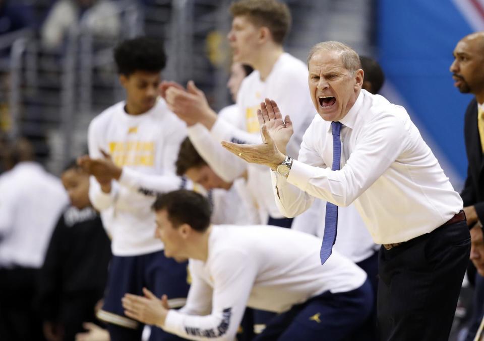 Michigan head coach John Beilein, right, encourages his team during the first half of an NCAA college basketball game against Purdue in the Big Ten tournament, Friday, March 10, 2017, in Washington. (AP Photo/Alex Brandon)