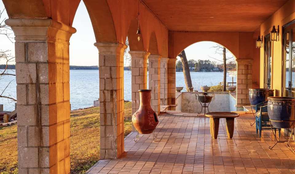 The house has a covered terrace and a patio facing Lake Murray. Ellis Creek/photography