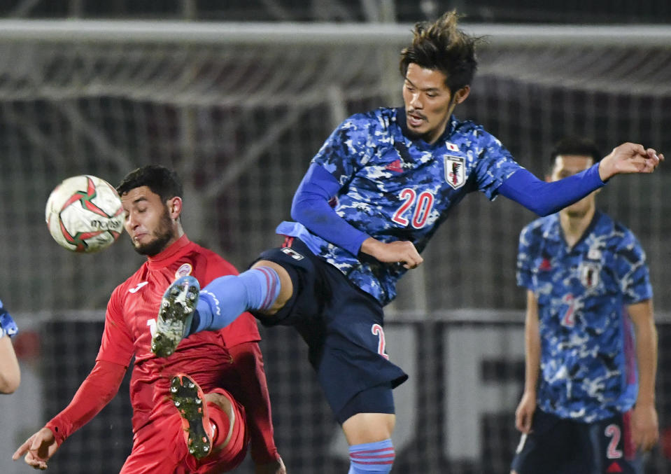 Japan's Yamaguchi Hotaru, right, fights for the ball with Kyrgyzstan's Murolimzhon Akhmedov during the World Cup 2022 Qualifying Asian zone Group F soccer match between Kyrgyzstan and Japan in Bishkek, Kyrgyzstan, Thursday, Nov. 14, 2019. (AP Photo/Vladimir Voronin)