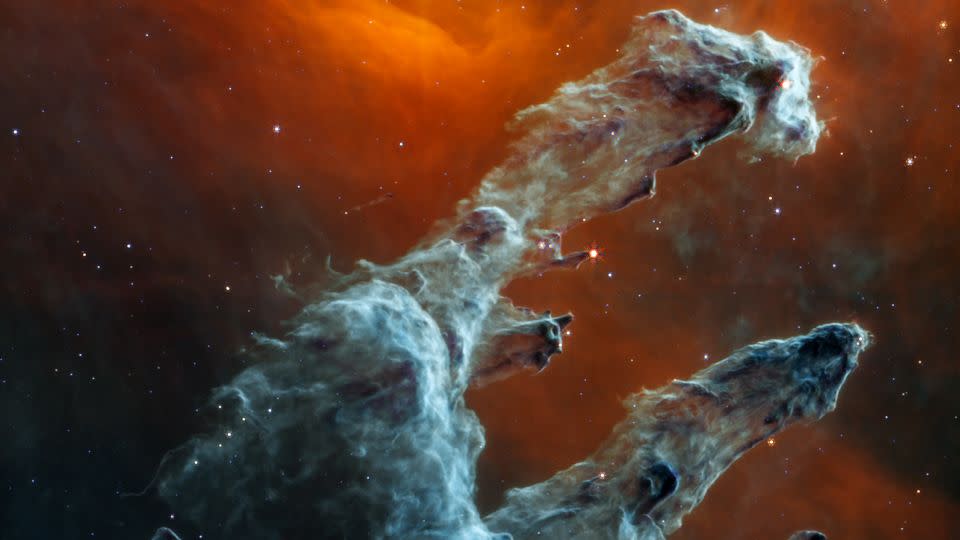 The James Webb Space Telescope captured a new perspective of the Pillars of Creation in mid-infrared light. The dust of this star-forming region is the highlight and resembles ghostly figures. - NASA/ESA/CSA/STScI