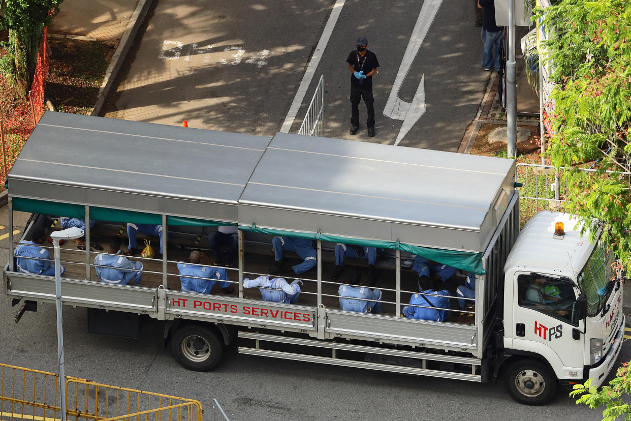 SINGAPORE - MAY 05:  Foreign workers working in the essential services practise safe distancing on-board a lorry on May 5, 2020 in Singapore. Singapore is now battling to control a huge outbreak in the coronavirus (COVID-19) local transmission cases among the migrant workers.  (Photo by Suhaimi Abdullah/Getty Images)