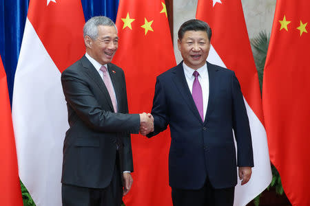 Singapore Prime Minister, Lee Hsien Loong shakes hands with Chinese President Xi Jinping before a meeting at The Great Hall Of The People in Beijing, China September 20, 2017 REUTERS/Lintao Zhang/Pool