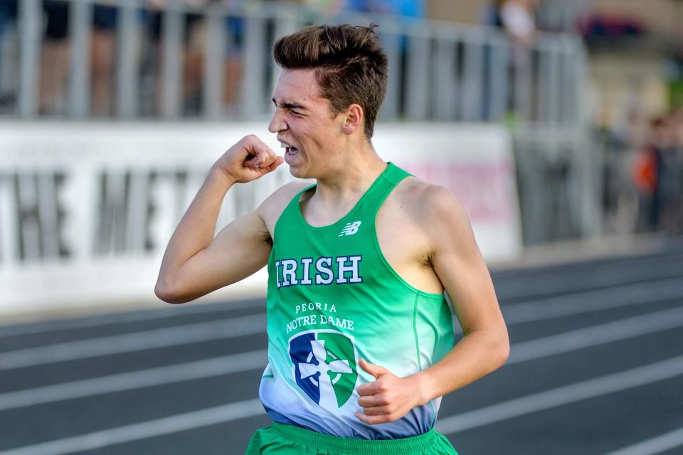 Peoria Notre Dame's Trey Socha celebrates as he wins the 3200-meter run in a personal best of 9:57.02 during the Class 2A Metamora Sectional track and field meet Wednesday, May 18, 2022 at Metamora High School.