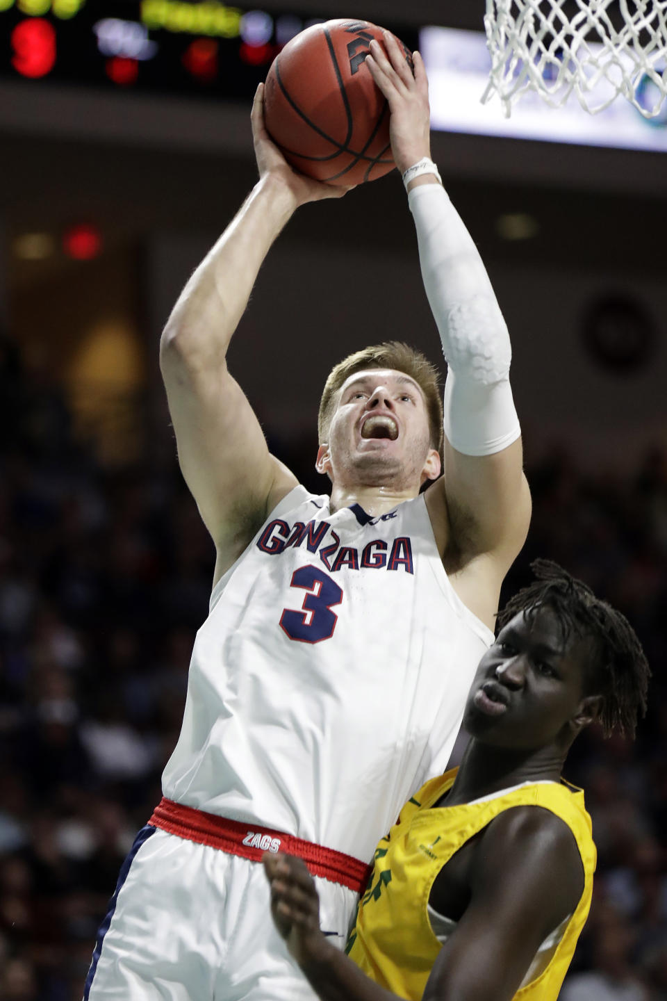 Gonzaga's Filip Petrusev (3) shoos as San Francisco's Josh Kunen defends during the first half of an NCAA college basketball game in the West Coast Conference men's tournament Monday, March 9, 2020, in Las Vegas. (AP Photo/Isaac Brekken)