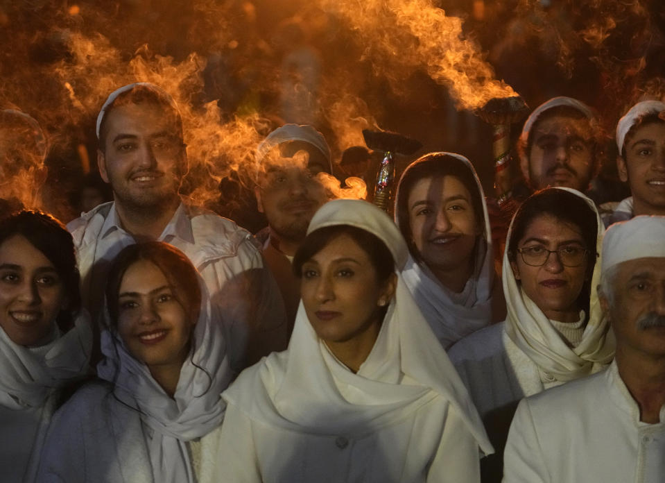 Iranian Zoroastrian youth pose for a photo after setting a prepared pile of wood on fire as they celebrate their ancient mid-winter Sadeh festival in the outskirts of Tehran, Iran, Tuesday, Jan. 30, 2024. Hundreds of Zoroastrian minorities gathered after sunset to mark their ancient feast, creation of fire, dating back to Iran's pre-Islamic past. (AP Photo/Vahid Salemi)