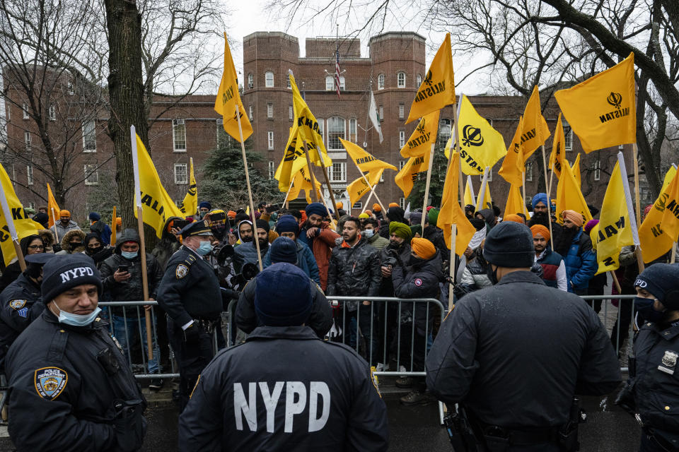 Protesters gather behind an NYPD barricade on Fifth Avenue outside the Consulate General of India, Tuesday, Jan. 26, 2021, in the Manhattan borough of New York. Tens of thousands of protesting farmers have marched, rode horses and drove long lines of tractors into India's capital, breaking through police barricades to storm the historic Red Fort. The farmers have been demanding the withdrawal of new laws that they say will favor large corporate farms and devastate the earnings of smaller scale farmers. Republic Day marks the anniversary of the adoption of India’s constitution on Jan. 26, 1950. (AP Photo/John Minchillo)