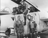 <p>John McCain (bottom right) poses with his U.S. Navy squadron in 1965. (Photo: National Archives/Handout via Reuters) </p>