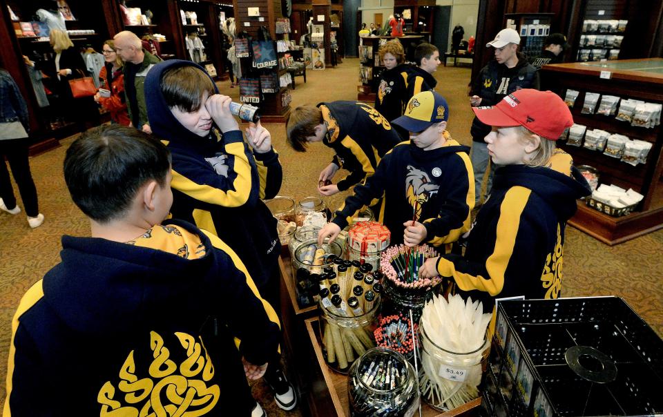 Members of a Ukrainian youth hockey team visiting Springfield look over items in the gift shop during a stop at the  Abraham Lincoln Presidential Library and Museum Thursday, March 23, 2023. 