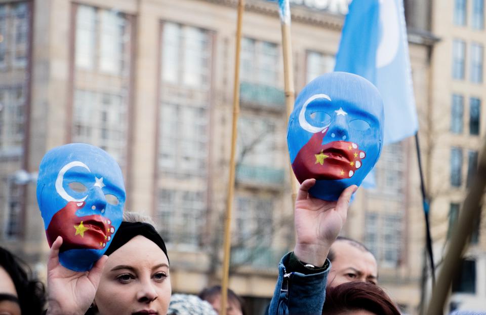 AMSTERDAM, NETHERLANDS - DECEMBER 29: People take part in a demonstration against Chinas persecution of Uighurs in Xinjiang, at Dam Square in Amsterdam, Netherlands on December 29, 2019. Chinas Xinjiang region is home to around 10 million Uighurs. The Turkic Muslim group, which makes up around 45% of Xinjiangs population, has long accused Chinas authorities of cultural, religious and economic discrimination. Up to one million people, or about 7% of the Muslim population in Xinjiang, have been incarcerated in an expanding network of political re-education camps, according to U.S. officials and UN experts. In a report last September, Human Rights Watch accused the Chinese government of carrying out a systematic campaign of human rights violations against Uighur Muslims in Xinjiang. (Photo by Abdullah Asiran/Anadolu Agency via Getty Images)