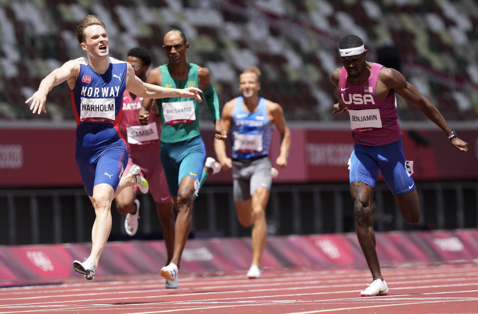 Karsten Warholm, of Norway celebrates as he wins the gold medal ahead of Rai Benjamin, of United States in the final of the men's 400-meter hurdles at the 2020 Summer Olympics, Tuesday, Aug. 3, 2021, in Tokyo, Japan. (AP Photo/Martin Meissner)