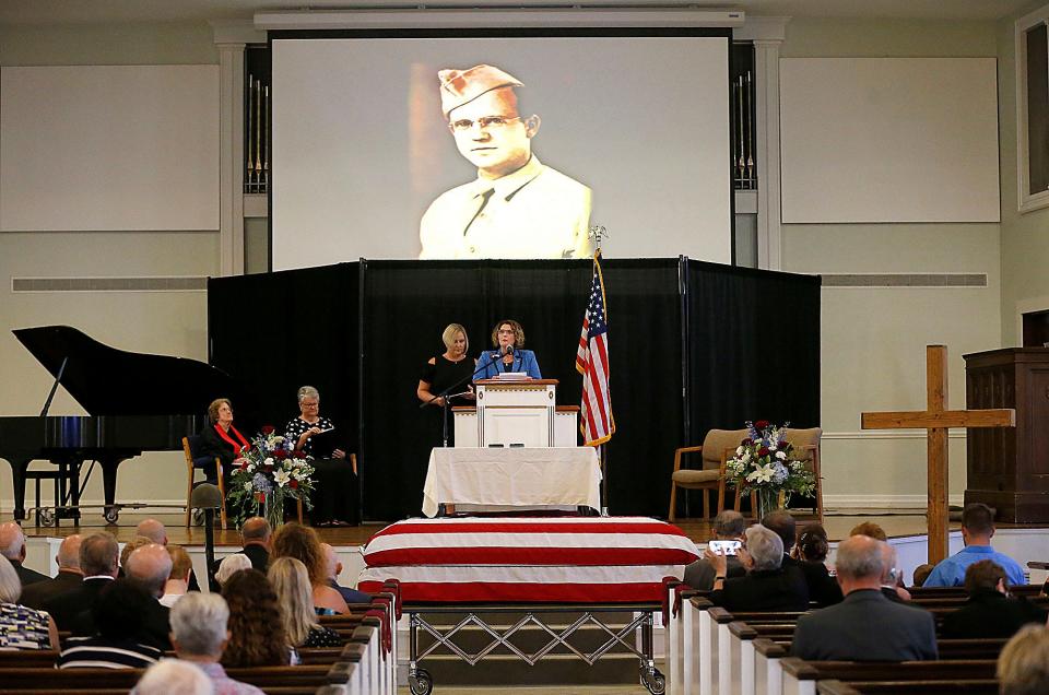 Army Pfc. Sanford Keith Bowen's granddaughters Lisa Simpson and Lori Reinbolt read the poem "Welcome Home" during the funeral service for the grandfather they never knew, who was killed during WWII.