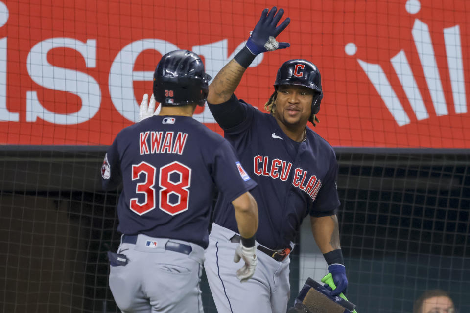 Cleveland Guardians' Steven Kwan, left, celebrates with José Ramírez after hitting a lead off home run during the first inning of a baseball game against the Texas Rangers, Sunday, July 16, 2023, in Arlington, Texas. (AP Photo/Gareth Patterson)